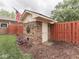 Brick shed in the backyard with a fence and landscaping at 2010 Alexandria Dr, Greenfield, IN 46140
