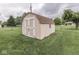 Backyard shed for extra storage in a fenced yard on a cloudy day at 2010 Alexandria Dr, Greenfield, IN 46140