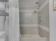 Beautiful shower with gray tiled walls, rainfall showerhead and hand shower, and neutral mosaic tile flooring at 2010 Alexandria Dr, Greenfield, IN 46140