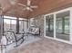 Sunroom with multiple seating options, tile floor, ceiling fan, and sliding glass doors to the exterior at 2010 Alexandria Dr, Greenfield, IN 46140