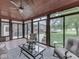 Relaxing sunroom with neutral paint, comfortable seating, tile floor, and backyard views at 2010 Alexandria Dr, Greenfield, IN 46140