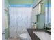 Bright bathroom showcasing a modern vanity, stylish fixtures, and a patterned shower curtain at 2021 Chestnut St, Columbus, IN 47201