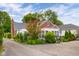 Home exterior with a partial view of the sunroom addition, surrounded by mature trees and landscaped gardens at 2021 Chestnut St, Columbus, IN 47201
