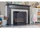 Close up of the fireplace showing the painted brick and mantle at 2021 Chestnut St, Columbus, IN 47201