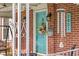Close-up of a charming front door featuring a wreath, decorative mailbox, and house number at 2021 Chestnut St, Columbus, IN 47201