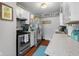 Kitchen with stainless steel appliances, white cabinetry, and lots of natural light, perfect for cooking and entertaining at 2021 Chestnut St, Columbus, IN 47201