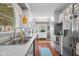 The well-lit kitchen features white cabinetry, stainless steel appliances, and a functional layout at 2021 Chestnut St, Columbus, IN 47201