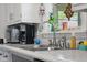 Close-up of a kitchen sink with stainless steel fixtures and a view of the window at 2021 Chestnut St, Columbus, IN 47201