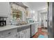 Bright kitchen sink area with a decorative window and white cabinets providing ample counter space at 2021 Chestnut St, Columbus, IN 47201
