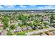 Vibrant community near an industrial area, showcasing neat lawns and diverse housing under a bright sky at 2110 Fisher Ave, Speedway, IN 46224