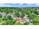 Lush neighborhood with mature trees surrounding well-maintained homes under a blue, partly cloudy sky at 2110 Fisher Ave, Speedway, IN 46224