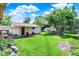 Landscaped backyard featuring green grass, a patio, and a lush garden, perfect for outdoor relaxation and entertainment at 2110 Fisher Ave, Speedway, IN 46224