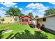 A spacious, green backyard with a partially fenced-in yard, lush lawn, ideal for outdoor enjoyment and activities at 2110 Fisher Ave, Speedway, IN 46224