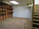 Unfinished basement with carpeted stairs, white walls, and neutral carpet, providing a blank canvas for future customization at 2110 Fisher Ave, Speedway, IN 46224