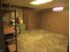 Finished basement with paneled walls, neutral carpet, and a built-in desk area, providing a functional and versatile space at 2110 Fisher Ave, Speedway, IN 46224