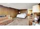 Basement space with wood paneling, sofas, and a bed, offering a versatile layout at 2110 Fisher Ave, Speedway, IN 46224