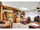 Finished basement area offering storage, shelving, and a workspace with a desk and dressers at 2110 Fisher Ave, Speedway, IN 46224