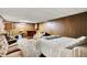 Retro basement rec room featuring a bar, seating area, and a bed for flexible living space at 2110 Fisher Ave, Speedway, IN 46224