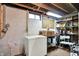 Unfinished basement area with storage shelves, a deep freezer, and basic utilities at 2110 Fisher Ave, Speedway, IN 46224