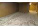 Unfinished basement space with paneled walls, carpeting, and an open doorway at 2110 Fisher Ave, Speedway, IN 46224