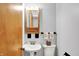 Bathroom featuring a pedestal sink, toilet, and a medicine cabinet mirror at 2110 Fisher Ave, Speedway, IN 46224