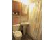 Cozy bathroom with a pedestal sink, matching vanity, and a shower with a patterned curtain adding warmth to the space at 2110 Fisher Ave, Speedway, IN 46224