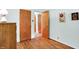 Bedroom with hardwood floors, closet and view to a hallway at 2110 Fisher Ave, Speedway, IN 46224