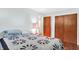 Comfortable bedroom features a quilt, hardwood floors, and closet space at 2110 Fisher Ave, Speedway, IN 46224