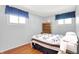 Cozy bedroom with hardwood floors, two windows, and neutral-colored walls at 2110 Fisher Ave, Speedway, IN 46224