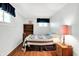 Cozy bedroom with natural light, hardwood floors, and a decorative quilt at 2110 Fisher Ave, Speedway, IN 46224