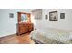 Bedroom with hardwood floors, dresser with mirror and floral decor at 2110 Fisher Ave, Speedway, IN 46224