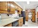 Classic kitchen featuring wood cabinets, a built-in desk, and standard appliances at 2110 Fisher Ave, Speedway, IN 46224