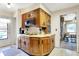 Eat-in kitchen with wood cabinets and white countertops overlooking the dining room at 2110 Fisher Ave, Speedway, IN 46224
