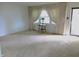 Bright living room featuring neutral carpet, a large window with curtains and a side door at 2110 Fisher Ave, Speedway, IN 46224