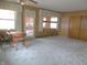 Room featuring paneled walls, neutral carpet, and natural light, creating a comfortable and adaptable space at 2110 Fisher Ave, Speedway, IN 46224