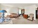 Cozy living room featuring neutral carpeting, a comfortable sofa, and bright natural light at 2110 Fisher Ave, Speedway, IN 46224
