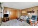Living room features carpeted floors, wood paneling, and a sliding door closet at 2110 Fisher Ave, Speedway, IN 46224