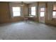 Bright room featuring paneled walls, neutral carpet, and natural light, creating a comfortable and adaptable space at 2110 Fisher Ave, Speedway, IN 46224
