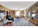 A living room showcases a table and chairs, a ceiling fan, and carpeted floors at 2110 Fisher Ave, Speedway, IN 46224