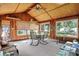 Bright sunroom featuring a vaulted ceiling, multiple windows, and an inviting table setting at 2110 Fisher Ave, Speedway, IN 46224