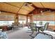 Bright sunroom featuring paneled walls, large windows with blinds, ceiling fan, dining set, and sofa at 2110 Fisher Ave, Speedway, IN 46224