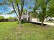 Inviting two-story home with fresh green lawn, mature trees and attached two car garage at 2116 Orchid Bloom Dr, Indianapolis, IN 46231