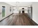Bright, open kitchen features stainless steel appliances and sleek white cabinetry and dark vinyl plank flooring at 2116 Orchid Bloom Dr, Indianapolis, IN 46231