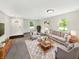 Bright living room featuring neutral tones, cozy seating, and ample natural light through large windows at 2116 Orchid Bloom Dr, Indianapolis, IN 46231