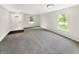Spacious living room with neutral paint, large windows offering natural light, and plush carpeting at 2116 Orchid Bloom Dr, Indianapolis, IN 46231