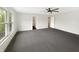Expansive main bedroom with large windows and neutral carpeting and paint with adjoining bathroom at 2116 Orchid Bloom Dr, Indianapolis, IN 46231