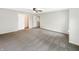 Bright main bedroom with ceiling fan, neutral carpeting, and large closet and view to en-suite bathroom at 2116 Orchid Bloom Dr, Indianapolis, IN 46231