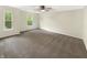 Large main bedroom with dual windows providing natural light and neutral carpeting and paint at 2116 Orchid Bloom Dr, Indianapolis, IN 46231