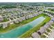 Aerial view of a community with landscaped streets and a picturesque lake running through the neighborhood at 220 Sawdust Trl, Greenfield, IN 46140