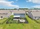 Aerial view of home's fenced backyard with a stone patio, landscaping, and a cozy fire pit area at 220 Sawdust Trl, Greenfield, IN 46140